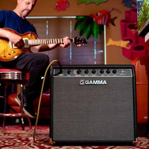 A man playing electric guitar through a Gamma G50 guitar amplifier