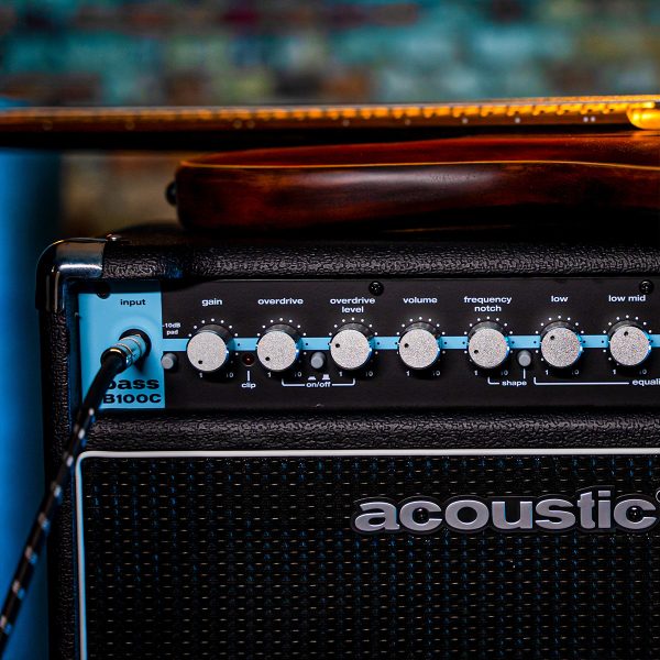 control panel B100C combo bass amp with a bass guitar laying on top of the amp