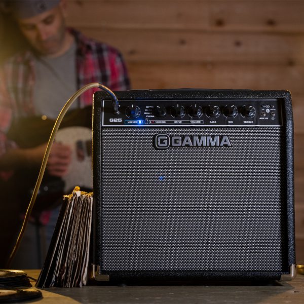 Guitar player stands behind GAMMA G25 guitar amp