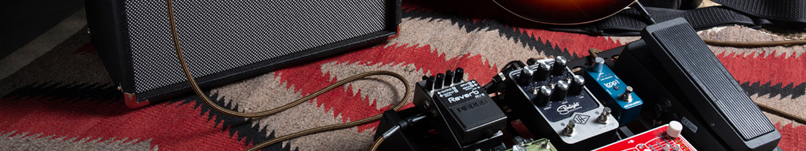Pedalboard with Loop1 looper effects pedal next to G50 guitar amp