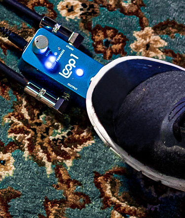 close up of guitar player foot pressing the LOOP1 Effect Pedal